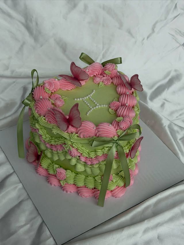 Green vintage Lambeth cake with piped bows and cherries, Austin TX
