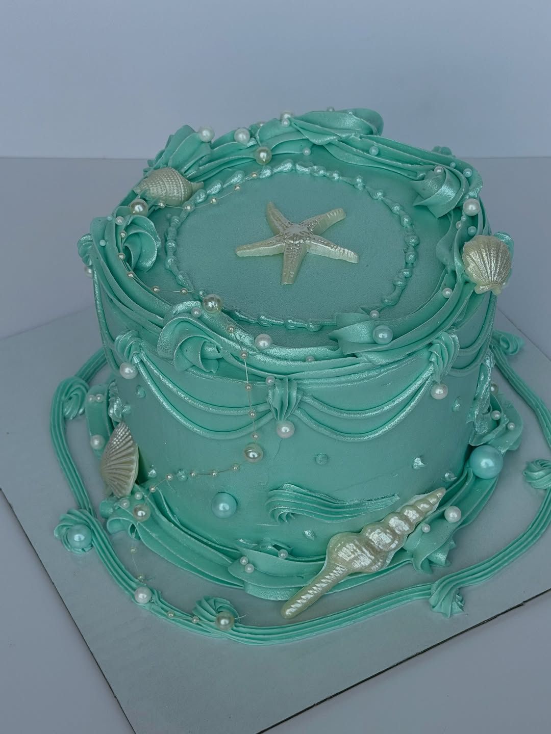 Seafoam mermaid cake with starfish, shells and pearls, Austin TX