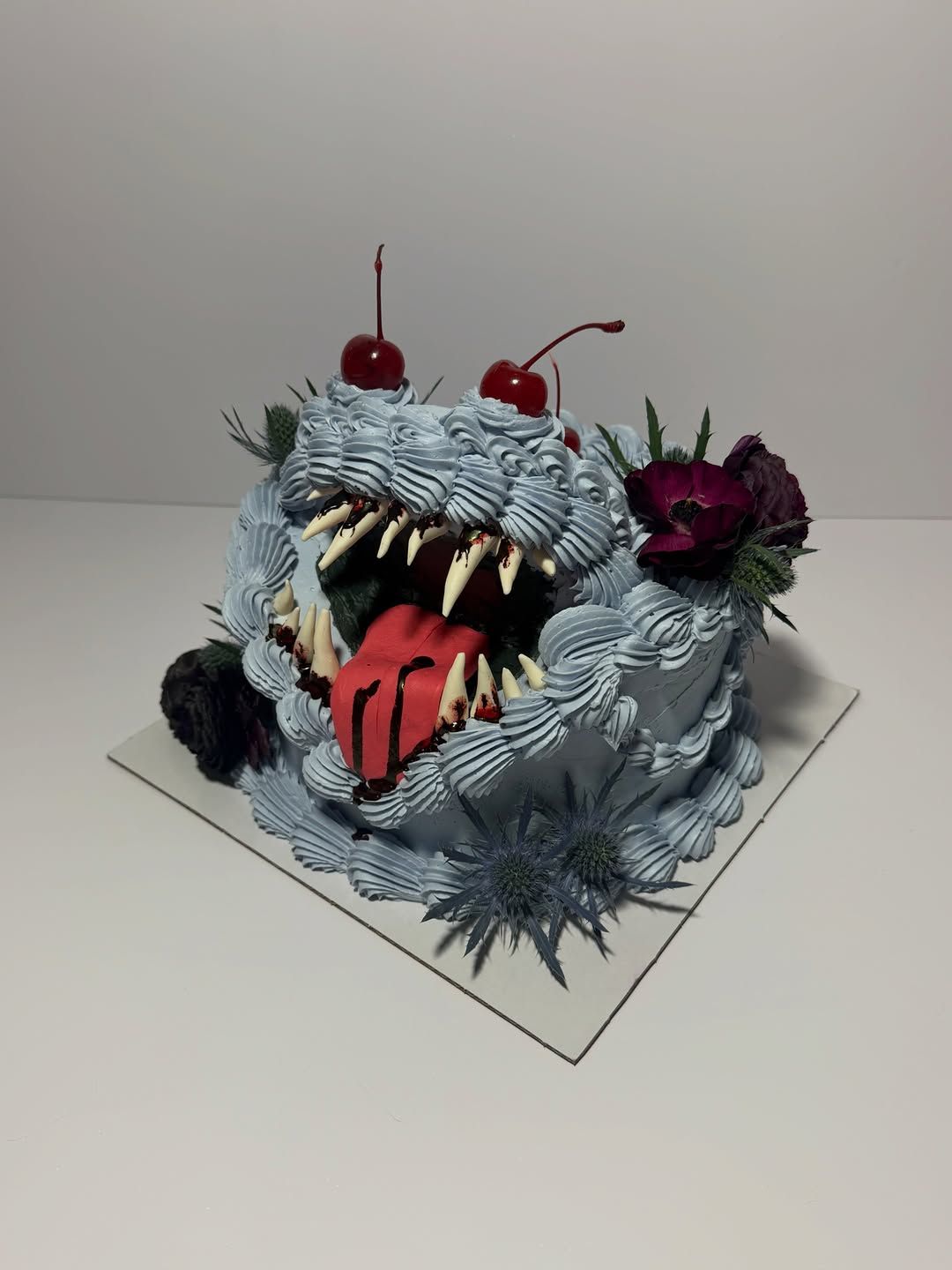 Sculptural grey buttercream monster cake with teeth, tongue and cherries, Austin TX