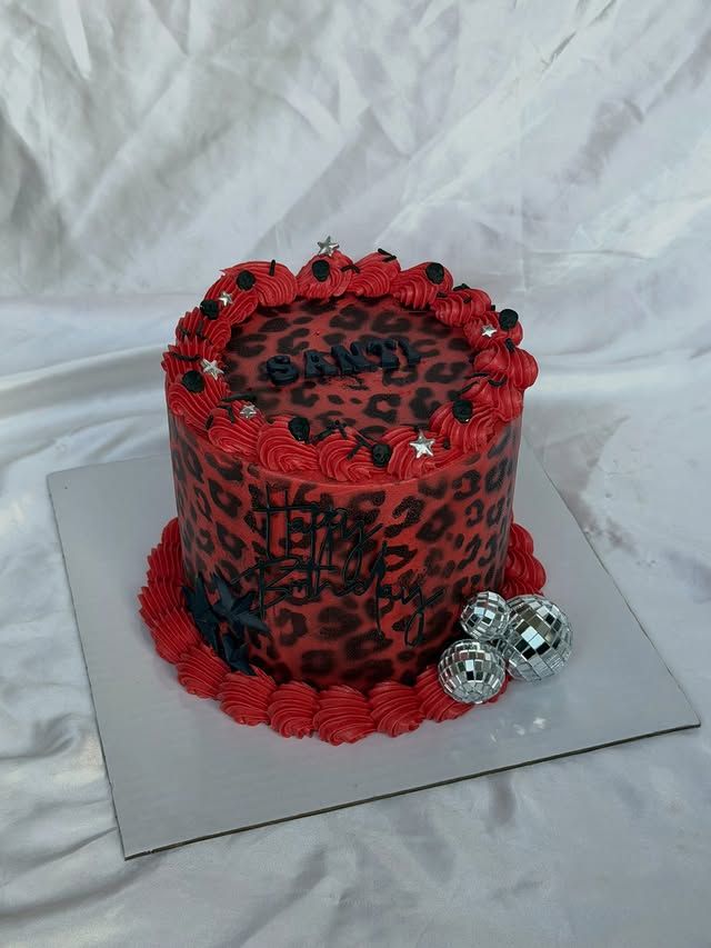 Tall red leopard-print buttercream birthday cake with cherries, Austin TX